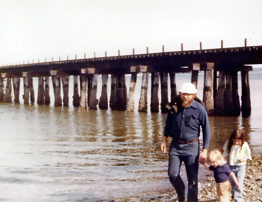 Charles as a child walking by the ocean with his father